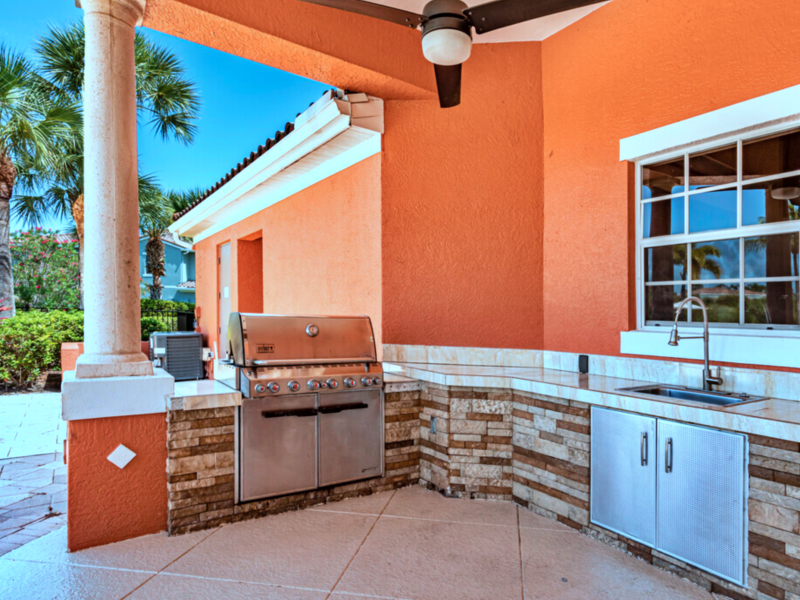 This image shows the outdoor kitchen, featuring the grilling area and lounge area with a swimming pool on the side. This area was ideal during the water fun experience.