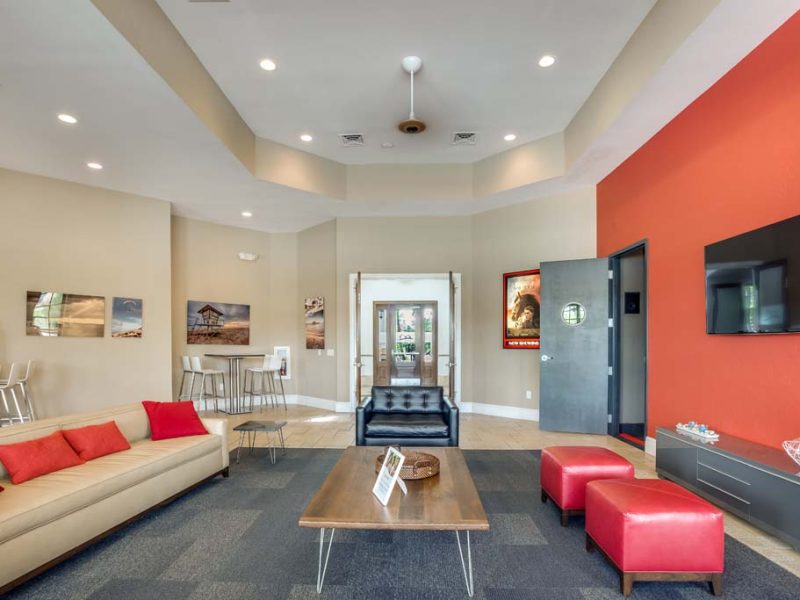 This image shows the front view of the luxury café lounge of TGM Malibu Lakes Apartment featuring the coffee tables stunning lights and paintings.