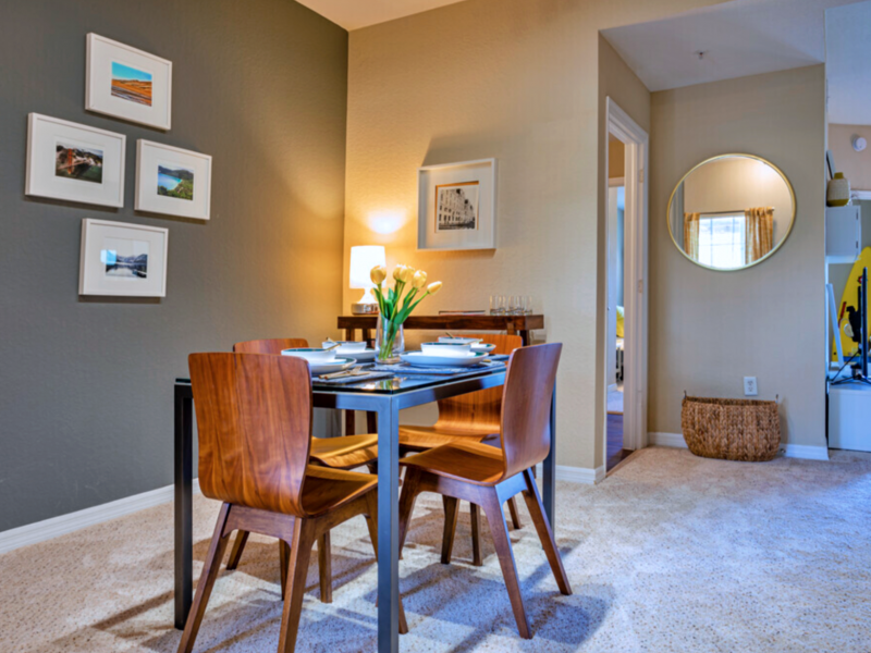 This image shows the Premium Apartment Featuring the dining room area showcasing a luxurious dining table and wooden chairs that were ideal for a perfect dining set-up.