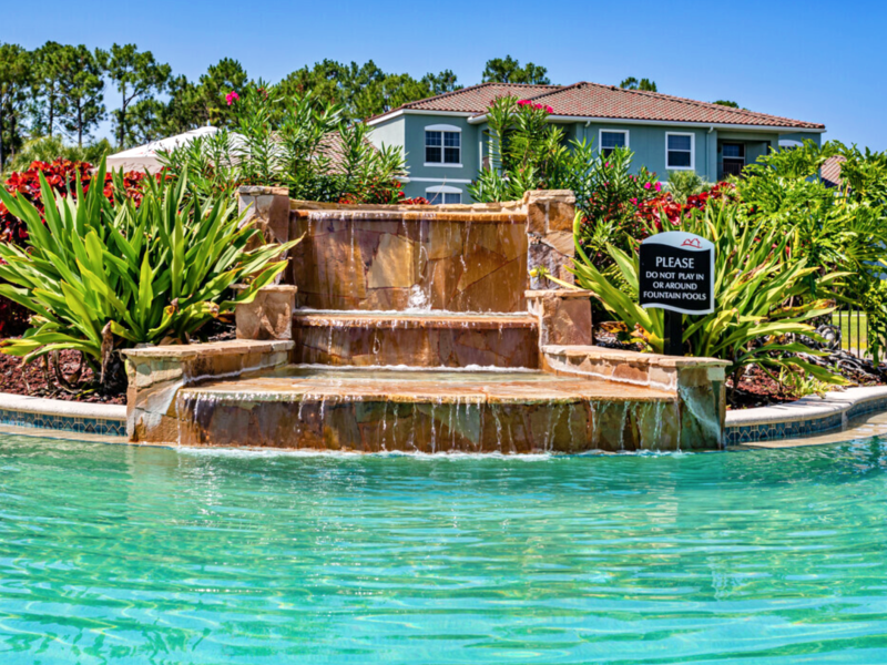 This image shows a sparkling Lagoon-style waterfall and spa with tranquil views.