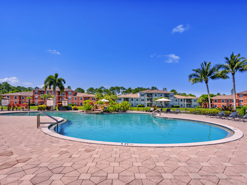 This image shows a relaxing Lagoon Style Waterfall and Spa with a tropical paradise ambiance.