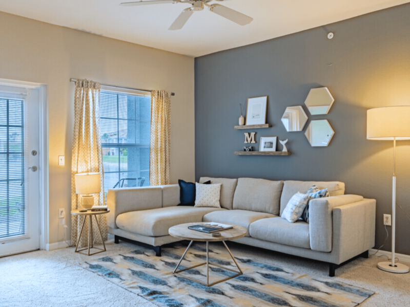 This image shows the expansive view of the living room area featuring the stunning home furniture and quick access directly through the dining area.